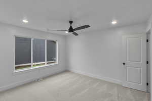 Spare room with light carpet, recessed lighting, and a ceiling fan