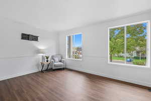 Unfurnished room featuring a textured ceiling, wood finished floors, and crown molding