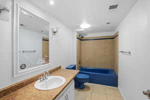 Full bathroom featuring light tile patterned flooring,  shower combination, and vanity