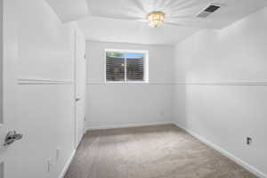 Unfurnished room with light carpet and a textured ceiling