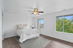 Bedroom featuring wood finished floors, a ceiling fan, and a textured ceiling