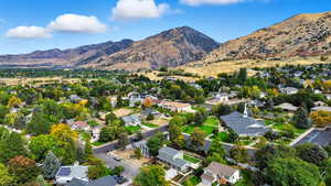 View of property location featuring nearby suburban area and a mountain backdrop