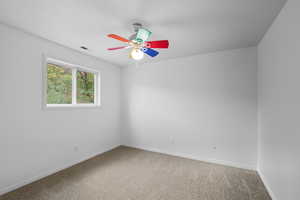 Unfurnished room with carpet and ceiling fan