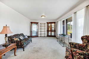 Sitting room featuring carpet floors