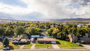 Aerial perspective of suburban area featuring a mountainous background and property parcel outlined