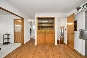 Kitchen with light wood-style floors and brown cabinetry