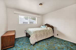 Carpeted bedroom featuring baseboards