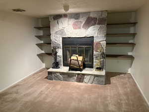 Detailed view of carpet floors and a fireplace