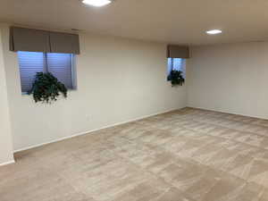 Below grade area featuring light carpet and recessed lighting