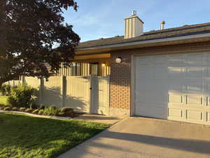 Single story home featuring brick siding and an attached garage