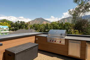 Patio / terrace featuring a mountain view and an outdoor kitchen