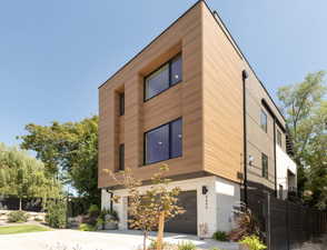 Contemporary home featuring brick siding, an attached garage, and concrete driveway