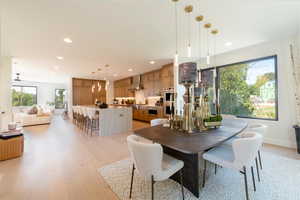 Dining space with light wood finished floors and recessed lighting