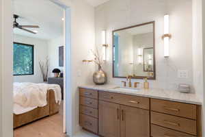 Bathroom featuring vanity, ensuite bathroom, and light wood-type flooring