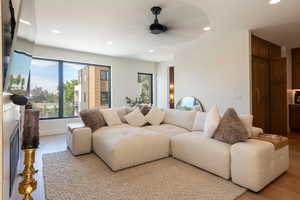 Living area with recessed lighting, plenty of natural light, light wood-style floors, and ceiling fan