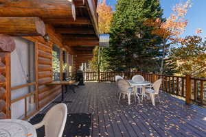 Wooden terrace featuring outdoor dining area and area for grilling