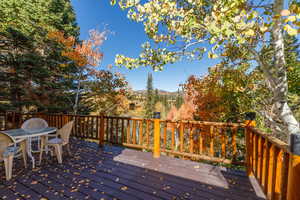 Deck featuring outdoor dining area and a mountain view