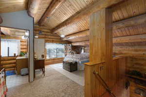 Bedroom featuring light carpet, rustic walls, and wood ceiling