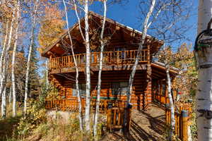 Back of house featuring log exterior