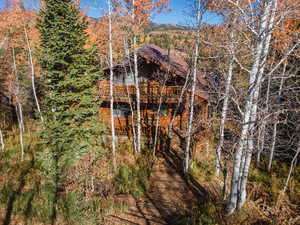 View of side of home with a shingled roof