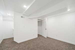 Finished basement bedroom with carpet floors and recessed lighting