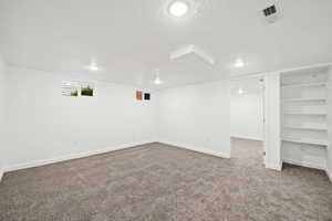 Basement featuring carpet floors, a textured ceiling, and recessed lighting