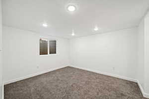 basement Family room featuring dark carpet and recessed lighting.