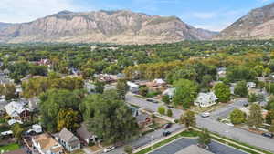 Aerial overview of property's location with a mountainous background and nearby suburban area