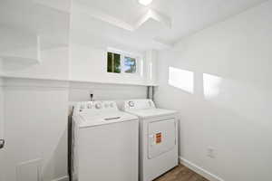 Laundry room featuring washing machine and dryer and LVP floors