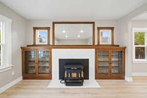 Living area with a wood stove and light wood-style flooring