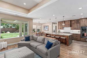 With large windows overlooking the backyard and a spacious kitchen, this room feels open, bright, and inviting.