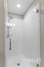 Shower upstairs with glass door.