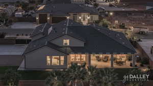 Evening backyard with lights on and a gas fire pit.