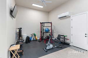 The mini split, TV and extra garage depth with exterior side door make this the perfect workout spot!