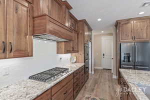 The kitchen leads to the pantry, desk drop zone and through the garage door with a large under stairs storage on the right.