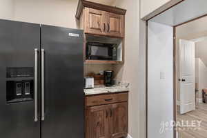 The pantry is home to a microwave and additional refrigerator with a countertop for small appliances so the kitchen stays clean!