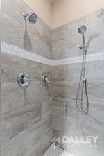 Double shower heads and beautiful tile surround in the walk-in shower.