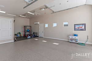 The garage is designed for year-round use, featuring clean epoxy floors, a mini-split system for heating and cooling, and ceiling fans for added comfort.