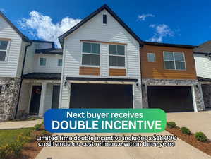 View of front of property with stone siding, a garage, and driveway