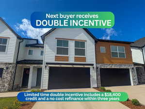 View of front facade featuring stone siding, a garage, and concrete driveway