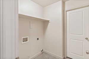 Washroom featuring hookup for a washing machine and electric dryer hookup