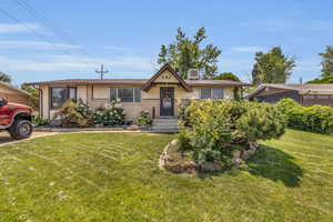 View of front of home with a front yard and brick siding