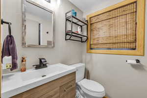 Bathroom with vanity and a textured wall