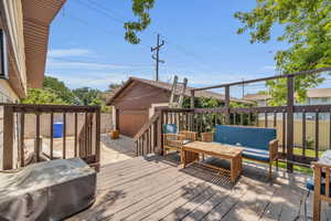 Deck featuring a detached garage and an outdoor structure