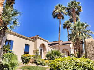 Mediterranean / spanish-style home with a tiled roof and stucco siding