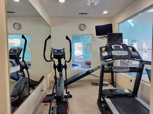 Workout room with recessed lighting and a ceiling fan