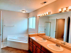 Primary Bath featuring a garden tub, double vanity, a separate Shower Primary Bath with Double Basins and Separate Soaking Tub and Shower Stall