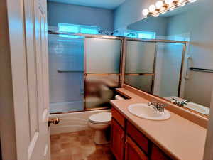 Hallway Bath with combined bath / shower with glass door and vanity