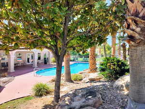 Community pool with a patio and french doors