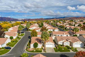 Aerial view of residential area featuring a mountainous background